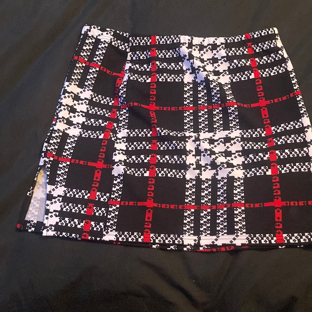 Plaid Red, White, and Black Mini skirt with mini slit at the bottom.